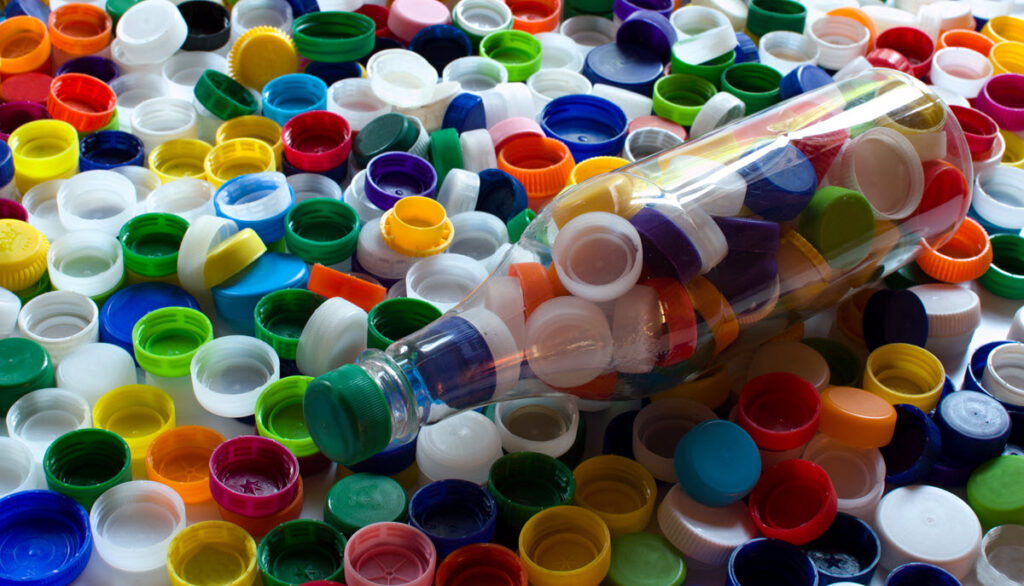 large multicoloured pile of bottle tops